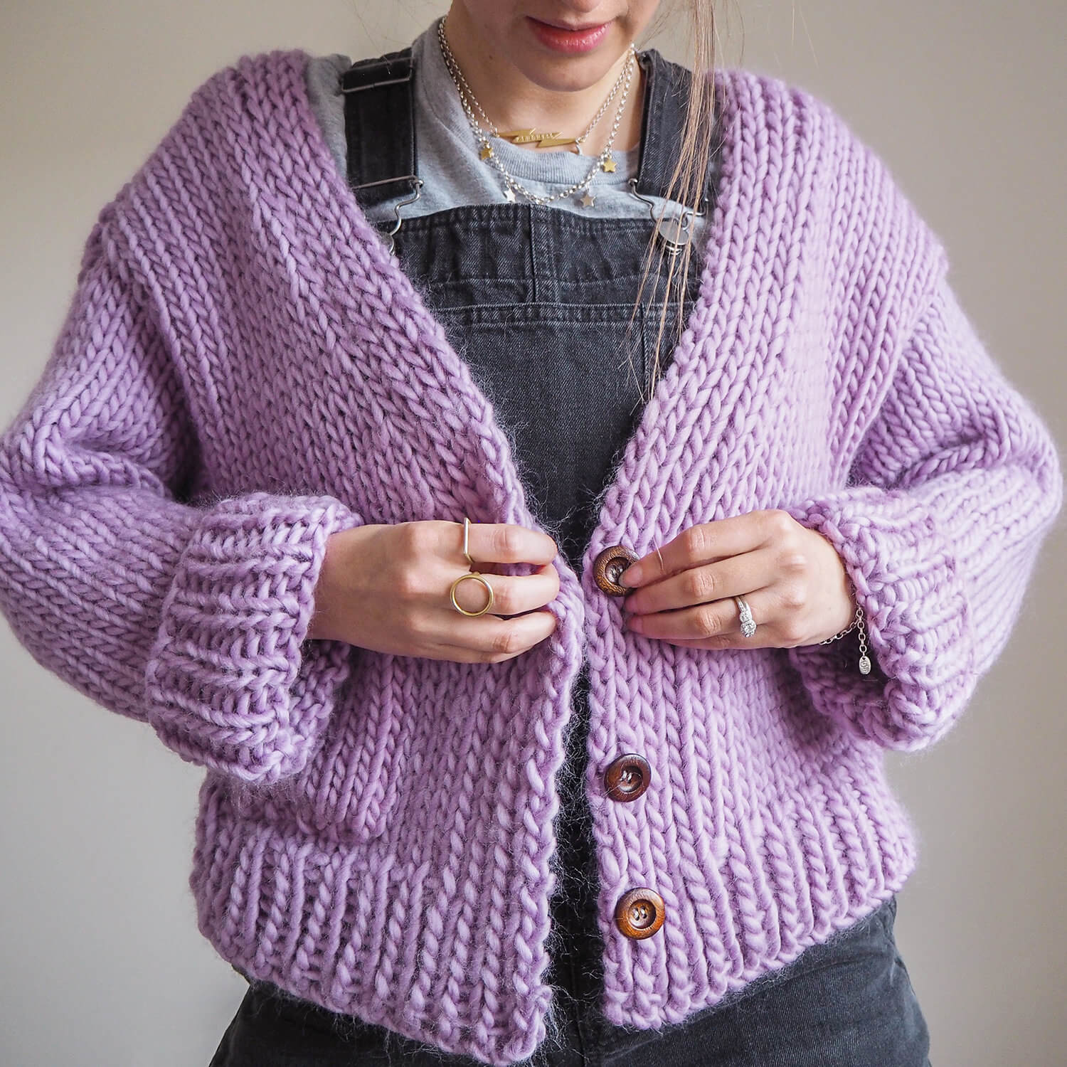 buttoning a cardigan